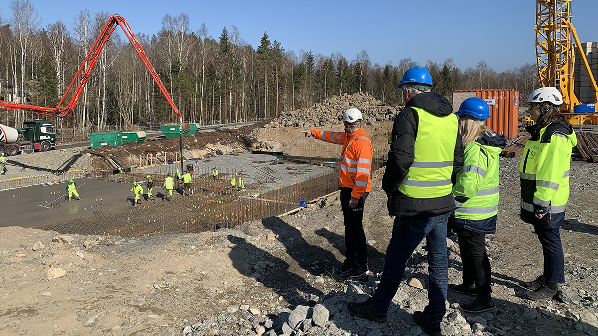 Personal från Peab och Härryda Vatten och Avfall AB tittar på när grunden till Hindås vattenverk gjuts. 